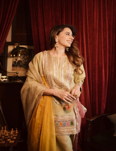 Woman in traditional outfit with red curtain background